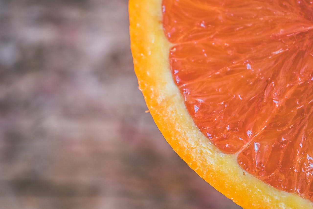 A detailed close-up image highlighting the vibrant, juicy flesh of an orange slice.