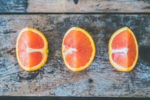 Vibrant orange slices beautifully arranged on a rustic wooden surface, showcasing fresh and juicy texture.
